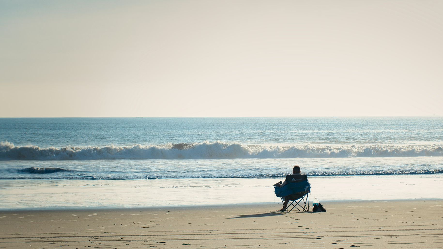 Waves rolling onto the wide sandy shoreline of Coronado Beach